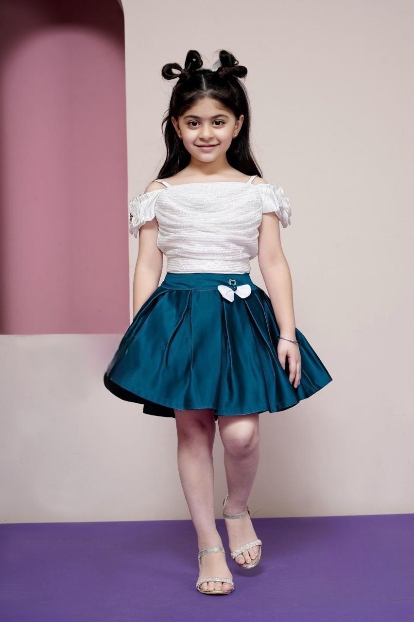 Manufacturer, Exporter, Importer, Supplier, Wholesaler, Retailer, Trader of White And Green Skirt Tops For Girls in New Delhi, Delhi, India